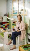 Nursery teacher sitting in the preschool play room photo