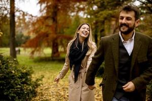 Young couple walking in the autumn park photo