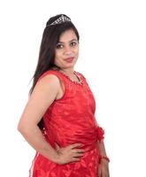 Young girl in red dress posing on white background photo