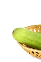 Fresh Cucumbers in basket isolated on white background photo