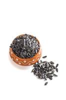 Sunflower Seeds in clay pot on white background. Helianthus annuus. photo