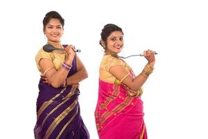 Young Traditional Indian Girls holding kitchen utensil on white background photo