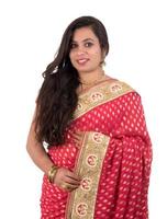 Beautiful young girl posing in Indian traditional saree on white background. photo