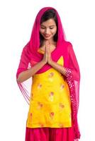 Beautiful Indian girl with welcome expression inviting, greeting Namaste. photo