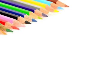 Colour pencils isolated on white background close up photo