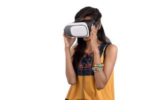 Beautiful girl looking though VR device. Young girl wearing virtual reality goggles headset. photo