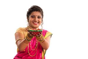 Portrait of a Indian Traditional Girl holding diya, Diwali or deepavali photo with female hands holding oil lamp during festival of light on white background