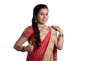 Beautiful young girl posing in Indian traditional saree on white background. photo