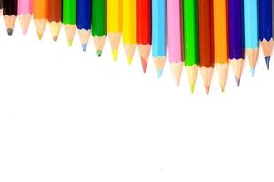 Colour pencils isolated on white background close up photo