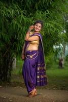 Indian Beautiful young girl in Traditional Saree posing outdoors photo