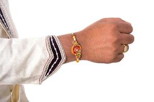 Indian festival Raksha Bandhan, Raakhi on hand, Sister tie Rakhi as symbol of intense love for her brother. photo