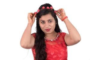 Young girl in red dress posing on white background photo