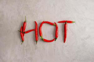 HOT lettering is lined with pods of red hot chili peppers photo