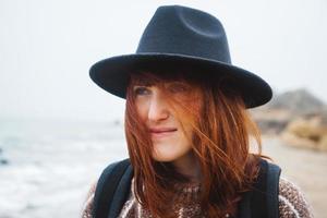 Portrait of a beautiful red-haired woman in a hat photo