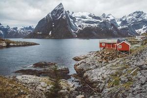 Norway rorbu houses and mountains rocks over fjord landscape scandinavian travel view Lofoten islands. Natural scandinavian landscape. photo