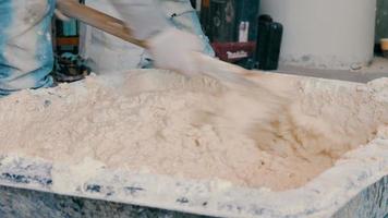 Construction worker mixing cement in salver video