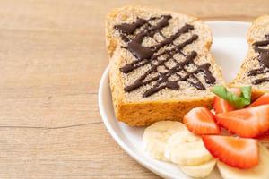 whole wheat bread with fresh banana, strawberry and chocolate