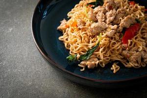 stir-fried instant noodles with basil and minced pork photo