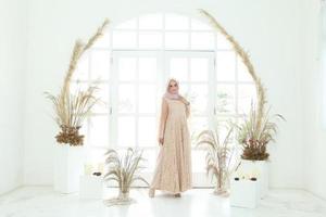 Full body portrait of lady use a wedding dress, wedding makeup on hijab. Malay or indonesia wedding dress, beauty or eidul fitri concept. Beautiful southeast asian muslim woman posing in islam dress photo