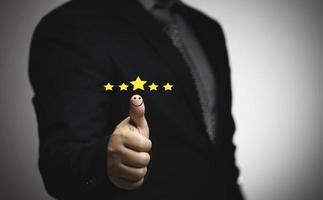 Business people thumb up positive thinking score a list of smile and stars for satisfaction on mobile service, online transactions, network performance, customer satisfaction. photo