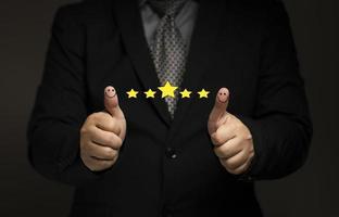 Business people thumb up positive thinking score a list of smile and stars for satisfaction. online transactions, network performance, customer satisfaction. photo
