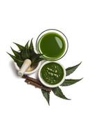 Medicinal Neem leaves in mortar and pestle with neem paste, juice and twigs on white background photo