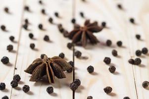 Spices and herbs. Food and cuisine ingredients. anise stars and black peppercorns on a wooden background. photo