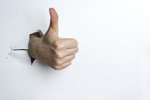 Female hand showing thumbs up on white background. photo