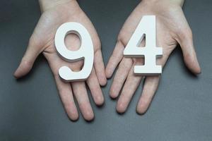 To female hands the figure of ninety-four. photo