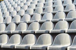 Gray chairs in the stands of the arena. photo