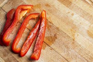 Sliced red pepper on a wooden Board. photo