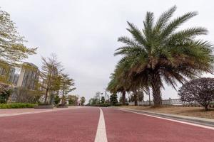 On a cloudy day, the red asphalt runway in the park photo