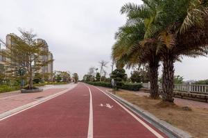 On a cloudy day, the red asphalt runway in the park photo