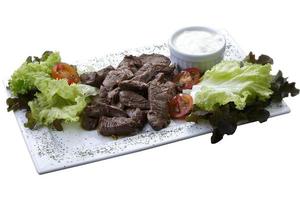 Filet mignon with salad and white sauce photo