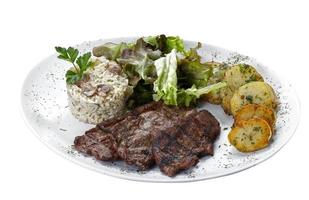 Beef steak with potatoes and rice in isolated white background photo