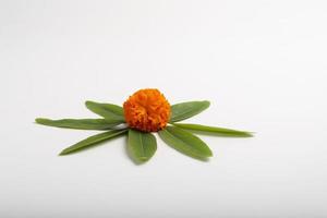 Marigold Flower rangoli Design with green leaf for traditional Festival. photo