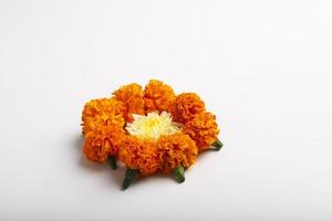 Marigold Flower rangoli Design with green leaf for traditional Festival. photo