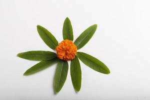 Marigold Flower rangoli Design with green leaf for traditional Festival. photo