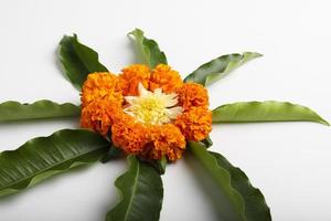 Marigold Flower rangoli Design with green leaf for traditional Festival. photo