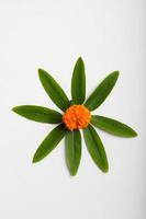 Marigold Flower rangoli Design with green leaf for traditional Festival. photo