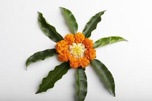 Marigold Flower rangoli Design with green leaf for traditional Festival. photo