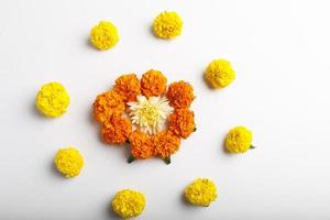 Marigold Flower rangoli Design with green leaf for traditional Festival. photo