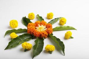 Marigold Flower rangoli Design with green leaf for traditional Festival. photo