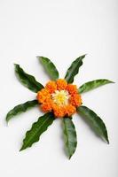 Marigold Flower rangoli Design with green leaf for traditional Festival. photo