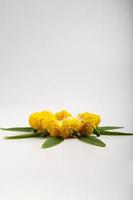 Marigold Flower rangoli Design with green leaf for traditional Festival. photo