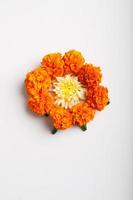 Marigold Flower rangoli Design with green leaf for traditional Festival. photo