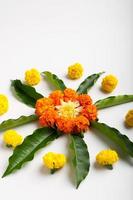Marigold Flower rangoli Design with green leaf for traditional Festival. photo