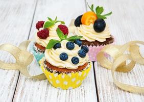 Cupcakes with fresh berries photo