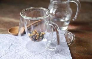 Cannabis leaf with flower tea in glass jar for healthy aroma drinking photo