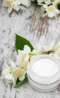 Moisturizing cream with jasmine flowers photo